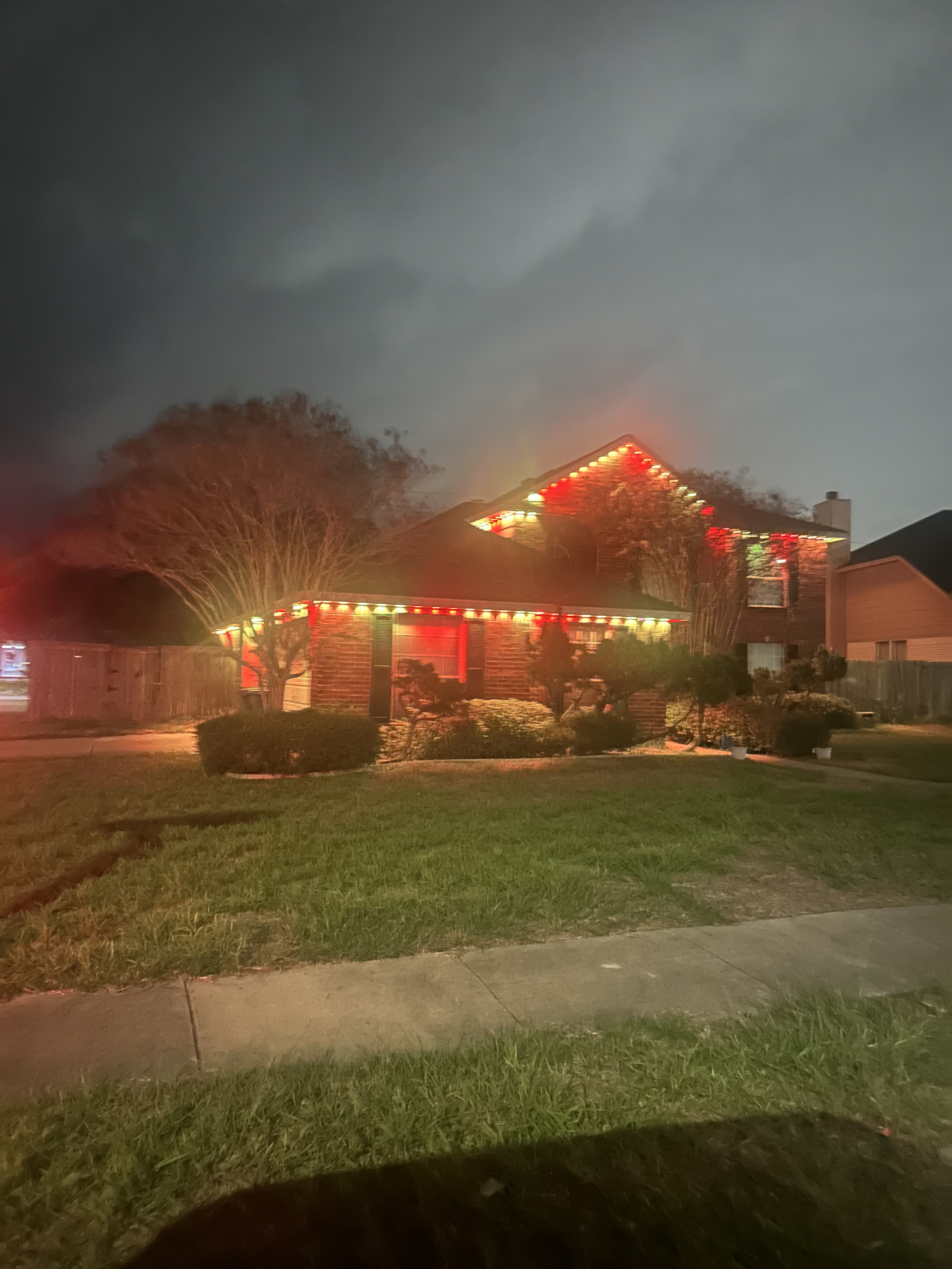 Teal green architectural wash permanent lighting on stucco home by H&L